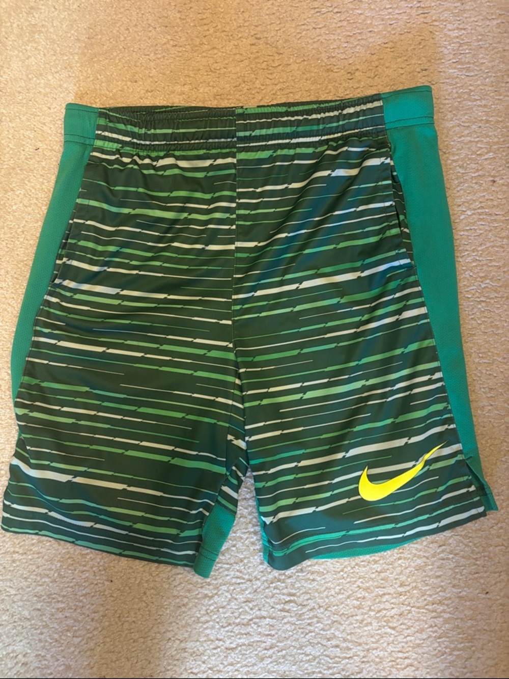 Nike Green Striped Shorts with Teal Panels and Yellow Swoosh